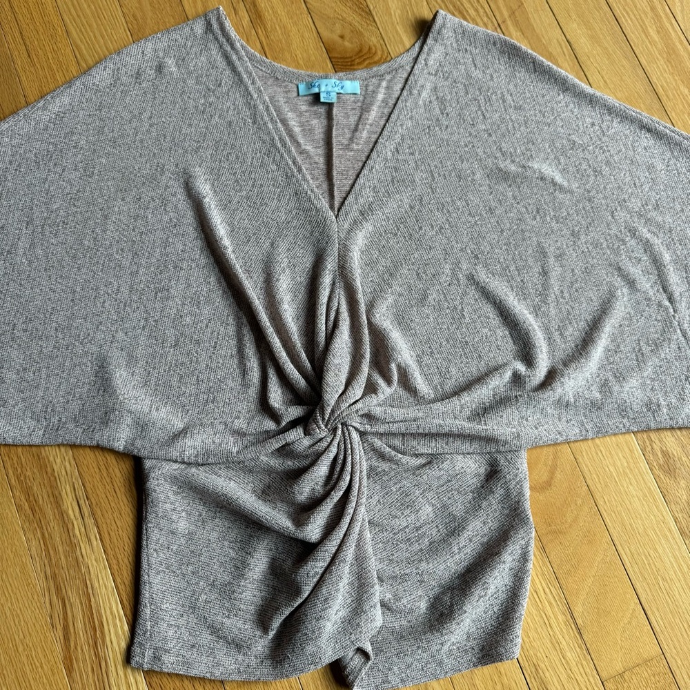 Champagne-colored short sleeve blouse with twist ruching at the waist